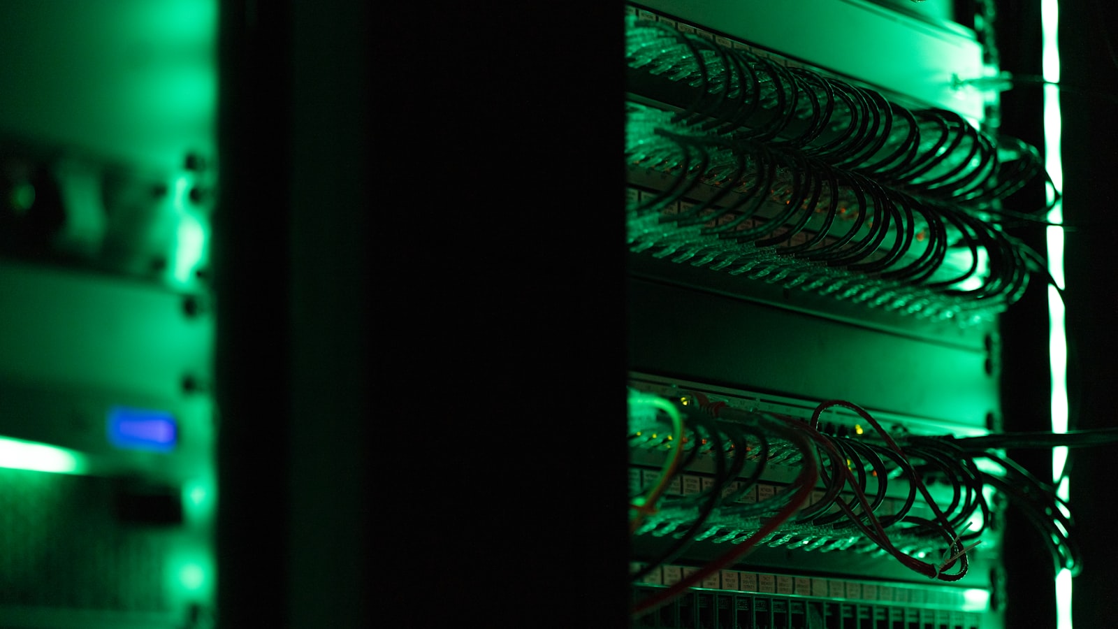 A rack of networking and server equipment in an operations room